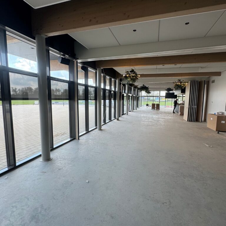 Doorkijk vanuit Jong Nederland via openstaande schuifdeuren richting kantine van Sport en Spel Reek.
